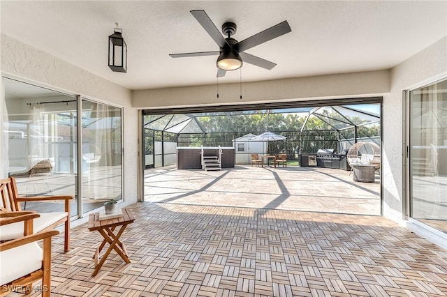 sunroom with plenty of natural light and a ceiling fan