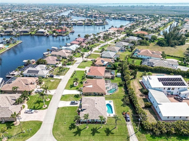 drone / aerial view featuring a residential view and a water view