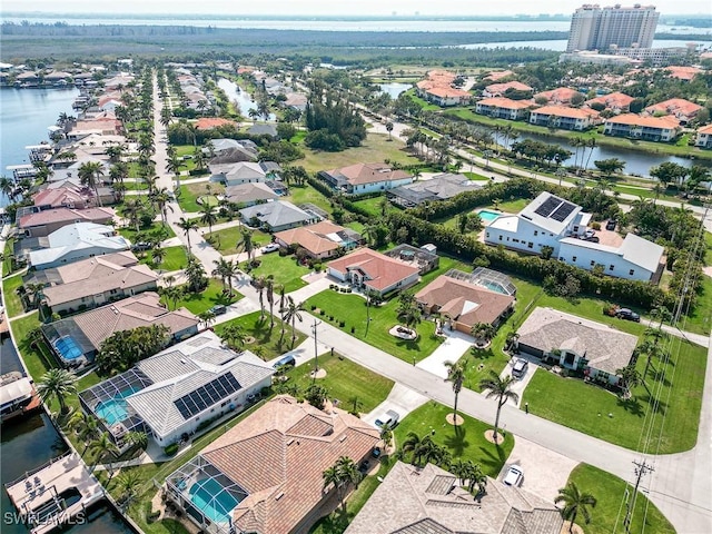 drone / aerial view with a water view and a residential view