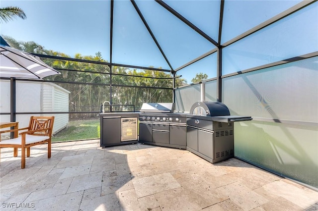 view of patio featuring a lanai, a grill, and exterior kitchen