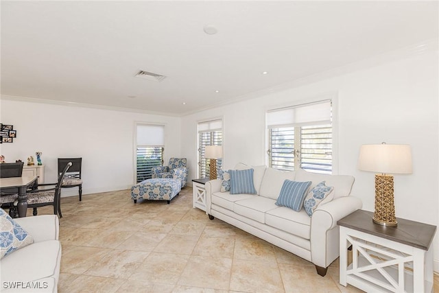 living room with crown molding, light tile patterned floors, baseboards, and visible vents