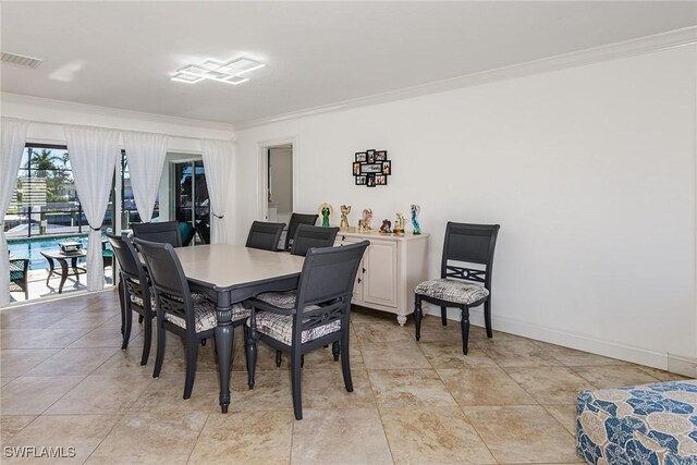 dining room with visible vents, baseboards, and ornamental molding