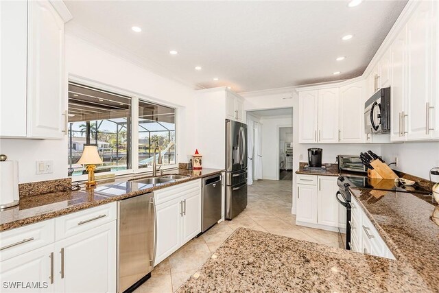 kitchen with white cabinets, black appliances, and dark stone countertops