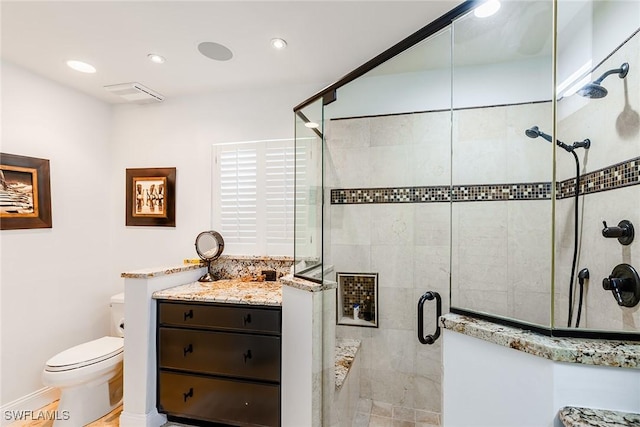 bathroom featuring recessed lighting, a shower stall, and toilet