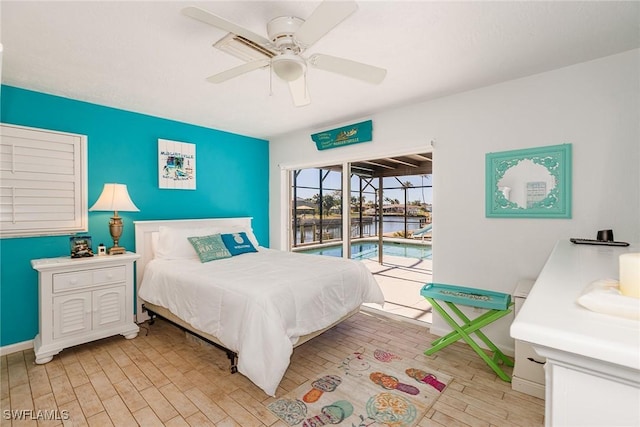 bedroom with light wood-type flooring, a sunroom, baseboards, and access to outside