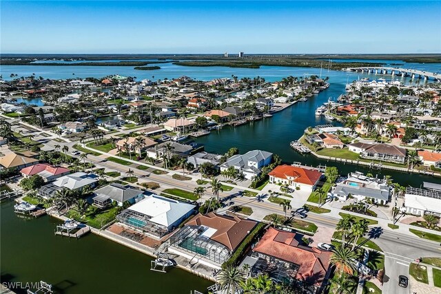 drone / aerial view featuring a residential view and a water view