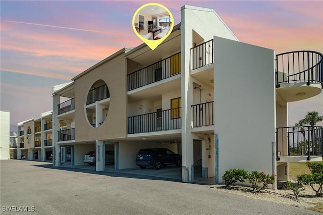 view of building exterior with covered parking
