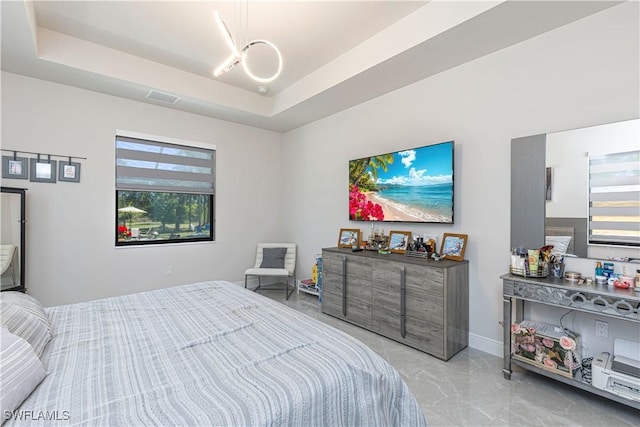 bedroom featuring visible vents, marble finish floor, a raised ceiling, and baseboards