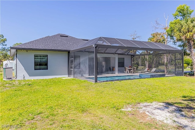 rear view of property with glass enclosure, an outdoor pool, stucco siding, a patio area, and a lawn