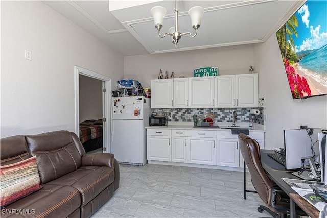 kitchen with open floor plan, white cabinets, light countertops, and freestanding refrigerator