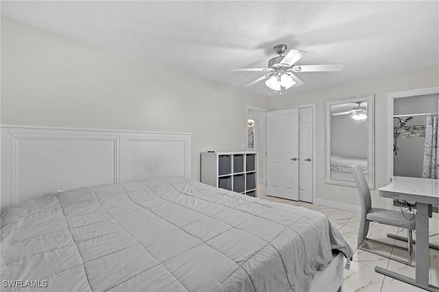 bedroom featuring marble finish floor, two closets, baseboards, and a ceiling fan