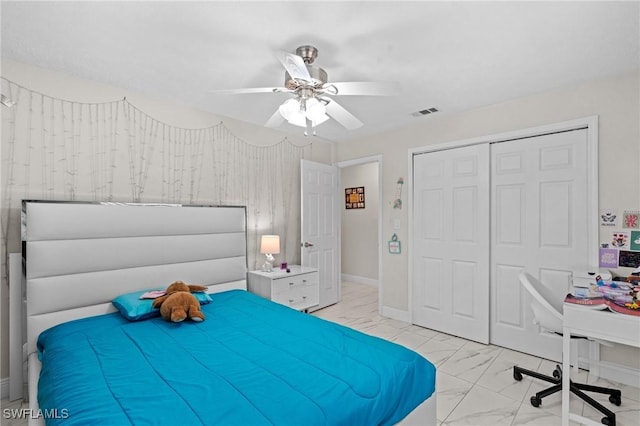 bedroom with visible vents, baseboards, a closet, marble finish floor, and a ceiling fan