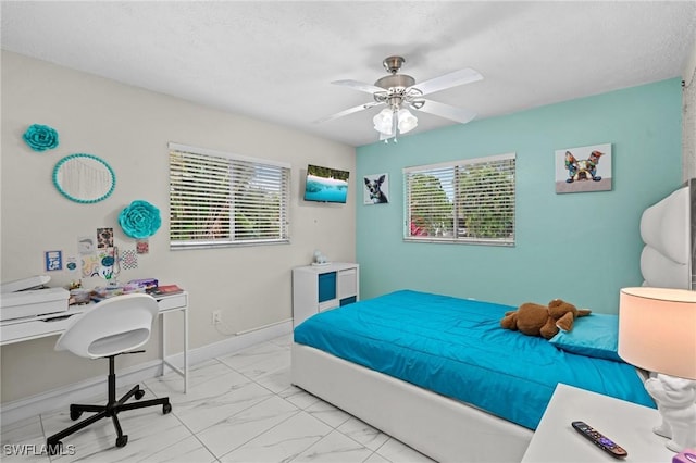 bedroom with marble finish floor, a textured ceiling, baseboards, and multiple windows