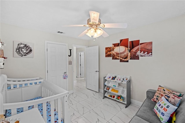 bedroom with visible vents, baseboards, marble finish floor, and a ceiling fan