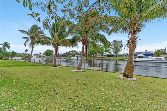 view of yard with a water view and fence