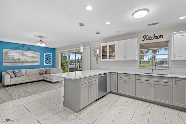 kitchen featuring a sink, visible vents, marble finish floor, and dishwasher