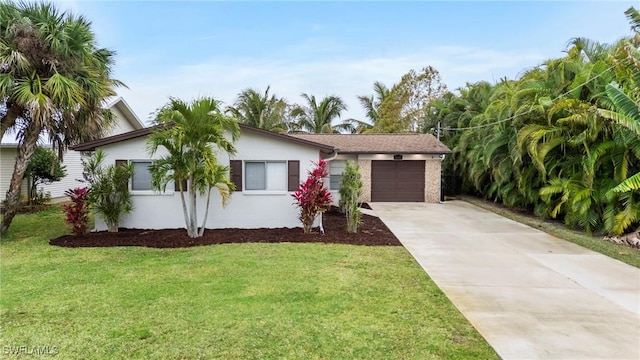 view of front of home with concrete driveway, an attached garage, a front lawn, and stucco siding