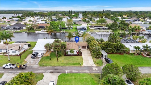 birds eye view of property with a residential view and a water view