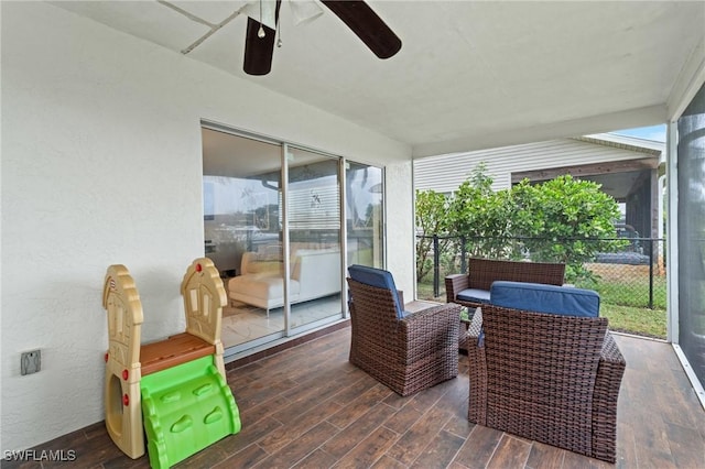 sunroom featuring ceiling fan