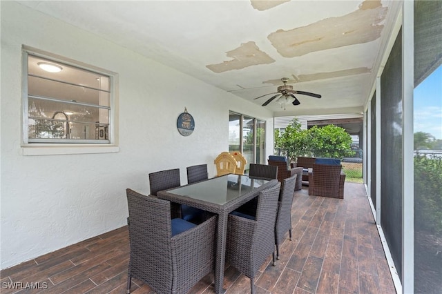 sunroom featuring a healthy amount of sunlight and ceiling fan