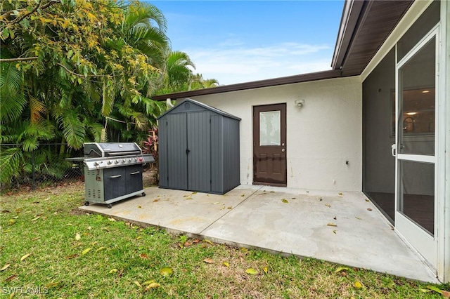 exterior space featuring a grill, a storage unit, an outdoor structure, and fence