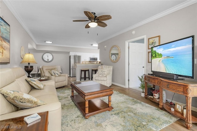 living area featuring ceiling fan, baseboards, wood finished floors, and ornamental molding