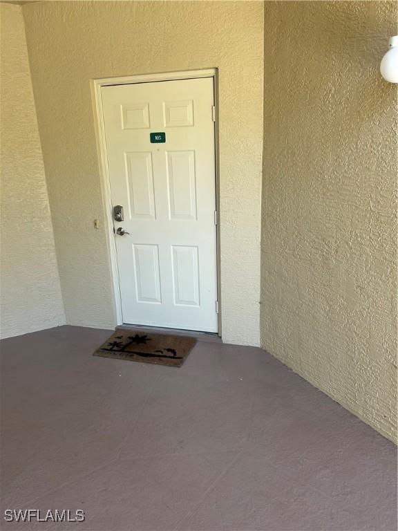 doorway to property with stucco siding