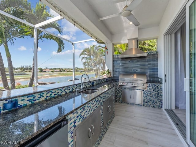 view of patio with grilling area, a lanai, area for grilling, a ceiling fan, and a sink