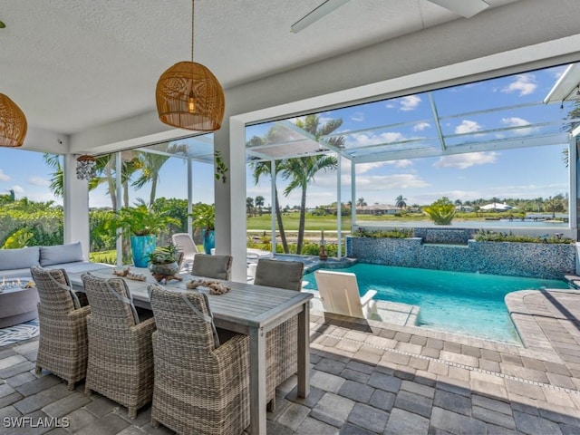 view of patio featuring outdoor dining space, a lanai, and an outdoor pool