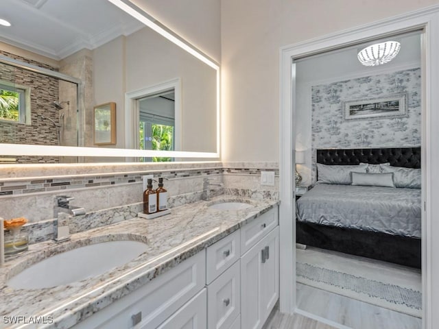 ensuite bathroom featuring a wealth of natural light, a shower stall, and a sink