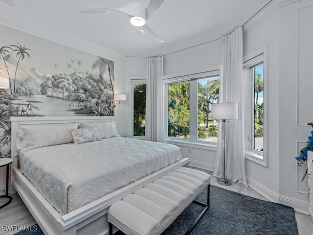 bedroom featuring a ceiling fan, crown molding, and baseboards