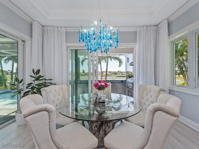 dining room with plenty of natural light, a notable chandelier, and crown molding