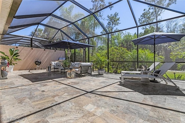 view of patio with an outdoor living space and glass enclosure