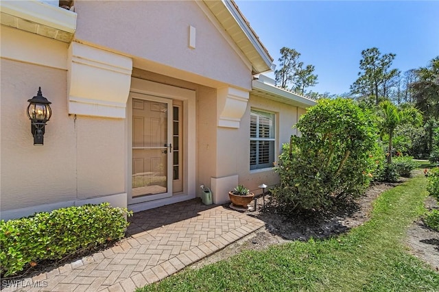 property entrance with stucco siding