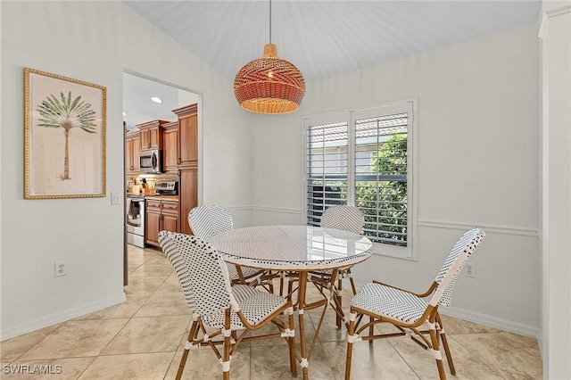 dining area featuring baseboards and light tile patterned flooring