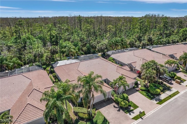 drone / aerial view featuring a wooded view