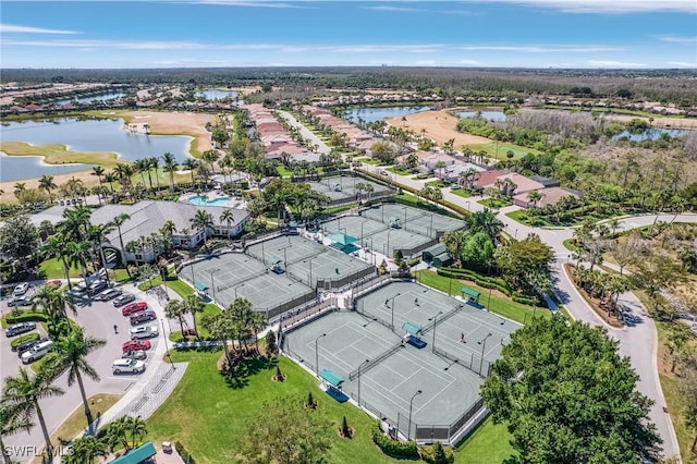 birds eye view of property with view of golf course, a water view, and a residential view