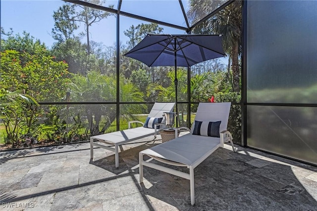 view of patio / terrace featuring glass enclosure