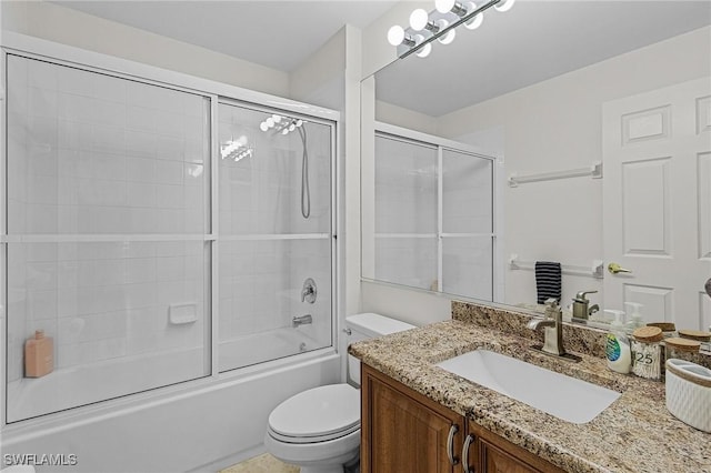 full bath featuring combined bath / shower with glass door, toilet, and vanity