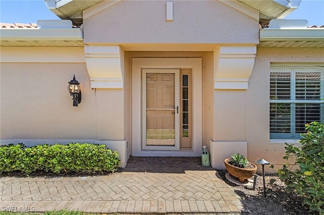 doorway to property with stucco siding