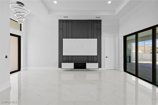 unfurnished room featuring recessed lighting, a raised ceiling, marble finish floor, and a towering ceiling