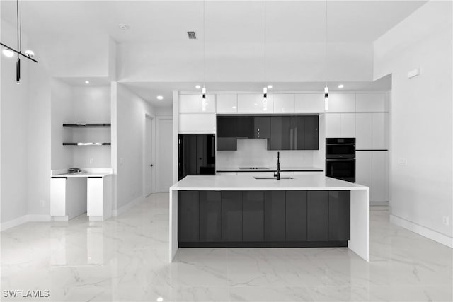 kitchen featuring white cabinets, modern cabinets, and a sink