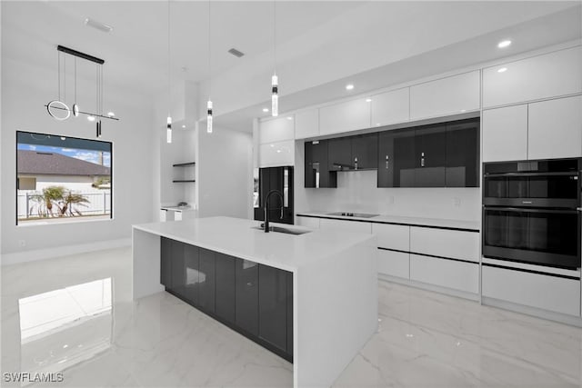 kitchen with a sink, white cabinetry, marble finish floor, black appliances, and modern cabinets