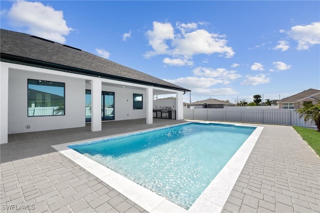 view of swimming pool featuring a patio, a fenced backyard, and a fenced in pool