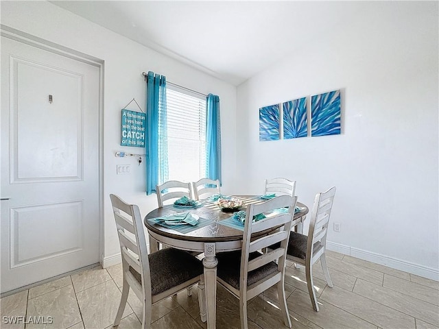 dining space featuring baseboards