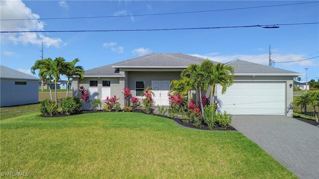 single story home featuring stucco siding, a front lawn, decorative driveway, an attached garage, and a shingled roof