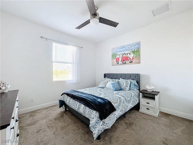 carpeted bedroom with visible vents, a ceiling fan, and baseboards