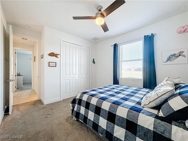 bedroom featuring visible vents, a ceiling fan, a closet, carpet flooring, and baseboards