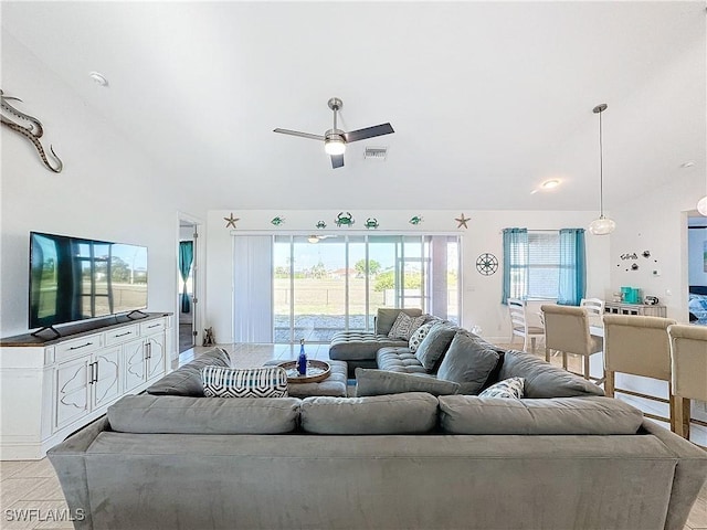 living area featuring a wealth of natural light, visible vents, and a ceiling fan