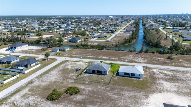 drone / aerial view featuring a residential view and a water view